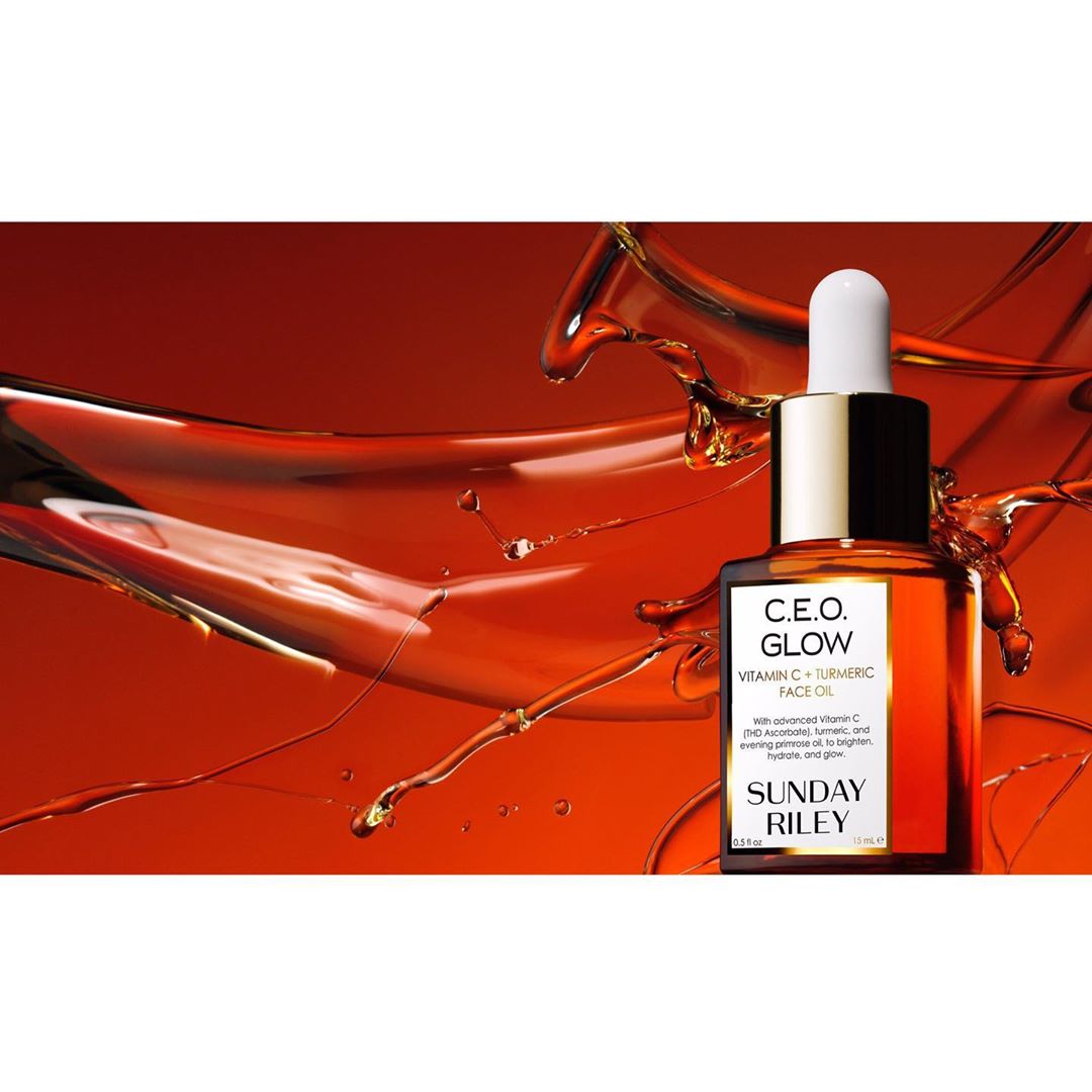 Product shot of Sunday Riley C.E.O. Glow Vitamin C and turmeric face oil in a brown bottle with a dropper, against an orange background.
