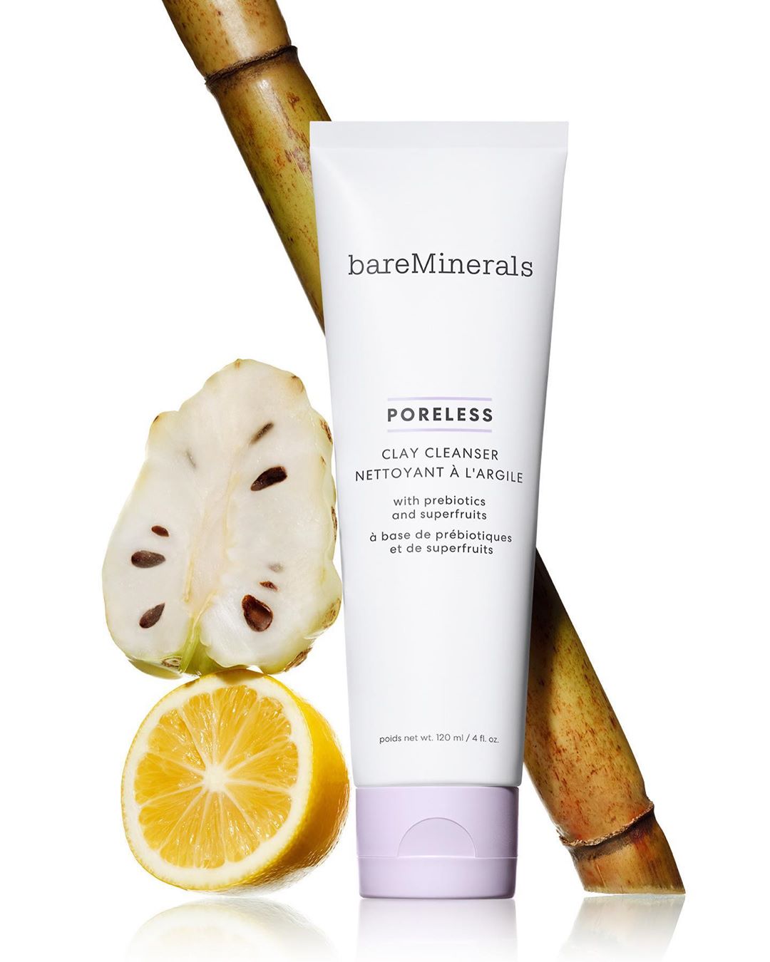 BareMinerals Poreless Clay Cleanser alongside a lemon, sugar cane, and a sugar apple slice, set against a clean white background.