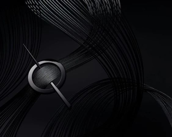 Abstract, high-angle studio shot: Black metal pin intersecting a circular ring resting on a surface with curved black strings.