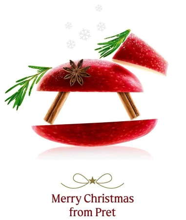 Festive Christmas apple still life composition with star anise, cinnamon sticks, and rosemary, isolated on a clean white background.