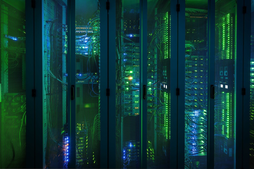 Data center servers with glowing lights and cables. Technology infrastructure and network communication hardware in a server room.
