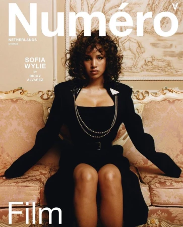 Magazine cover featuring Sofia Wylie sitting on a pink couch, wearing a black dress and silver necklace, in an indoor setting.