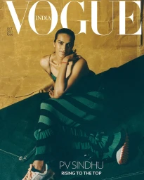 Magazine cover featuring athlete PV Sindhu seated wearing a green and black striped dress and sneakers against a textured backdrop