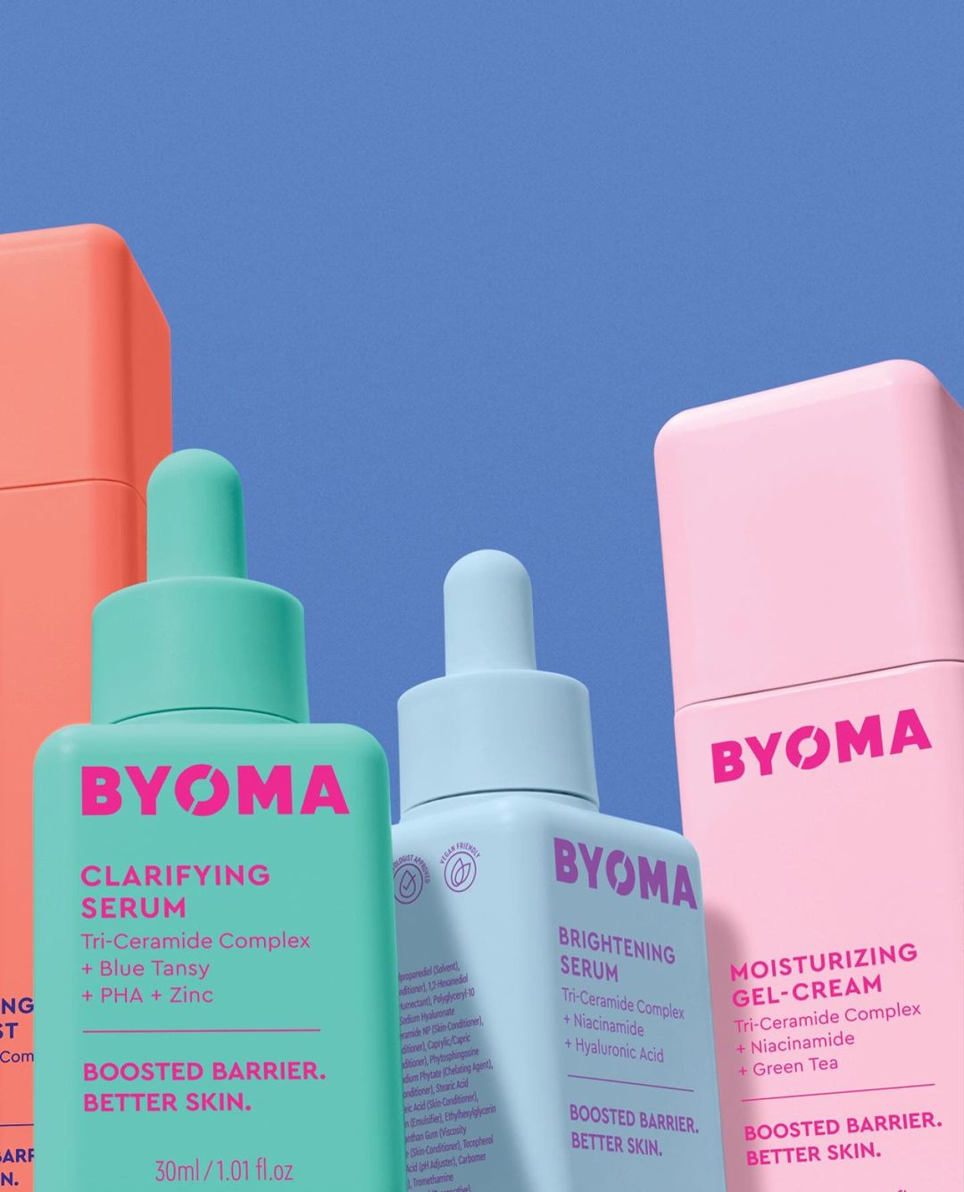 Byoma clarifying serum, brightening serum, and moisturizing gel cream in coral, teal, and pink packaging against a blue background.