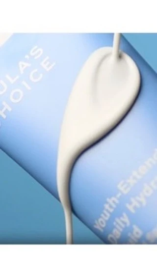 Cosmetic serum on blue tube with white fluid texture. Youth-Extending Daily Hydration Fluid is visible, for skincare or beauty.