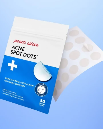 Acne spot treatment product showcasing a package of spot dots and a sheet of individual dots against a light blue background.