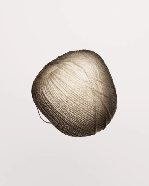 Close-up photo of a single ball of yarn in a soft neutral color, perfect for knitting or crochet projects with a smooth texture.