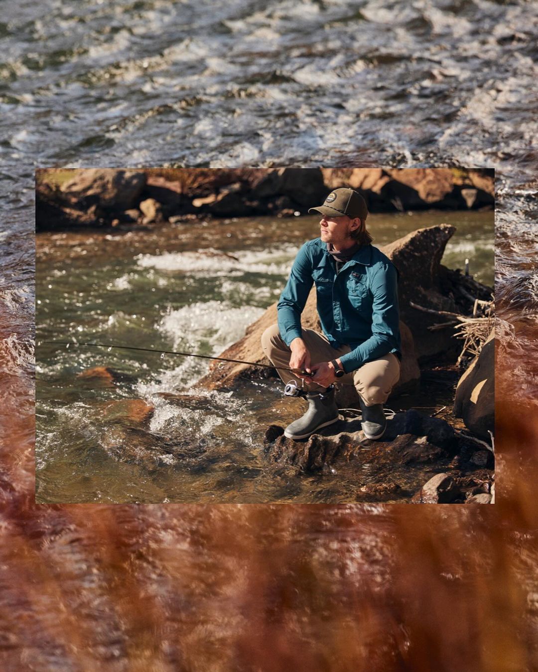 Angler in olive cap and turquoise button-down crouches on a rock in a river, holding a fishing pole. Water and rocks surround him.