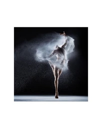 Dancer leaping with a cloud of white powder exploding around the body against a dark background