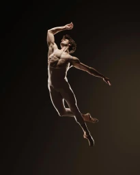 Male ballet dancer mid-air leaping in a white leotard against a dark studio background, photographed by Rj Muna.