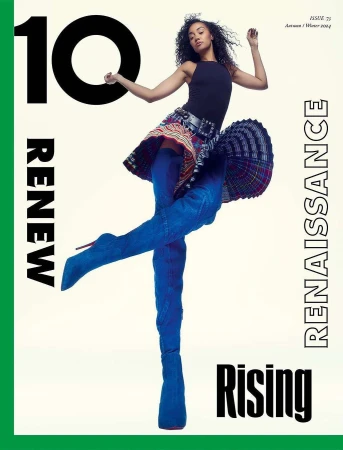 Woman in black top and pleated patterned skirt with blue thigh-high boots against a white backdrop