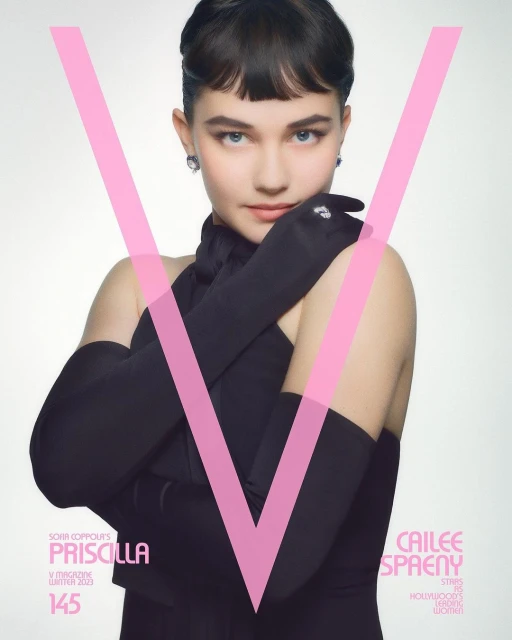 Cailee Spaeny poses in a black dress and long gloves for a magazine cover, featuring a pink 'V' design and clear, studio-style lighting.