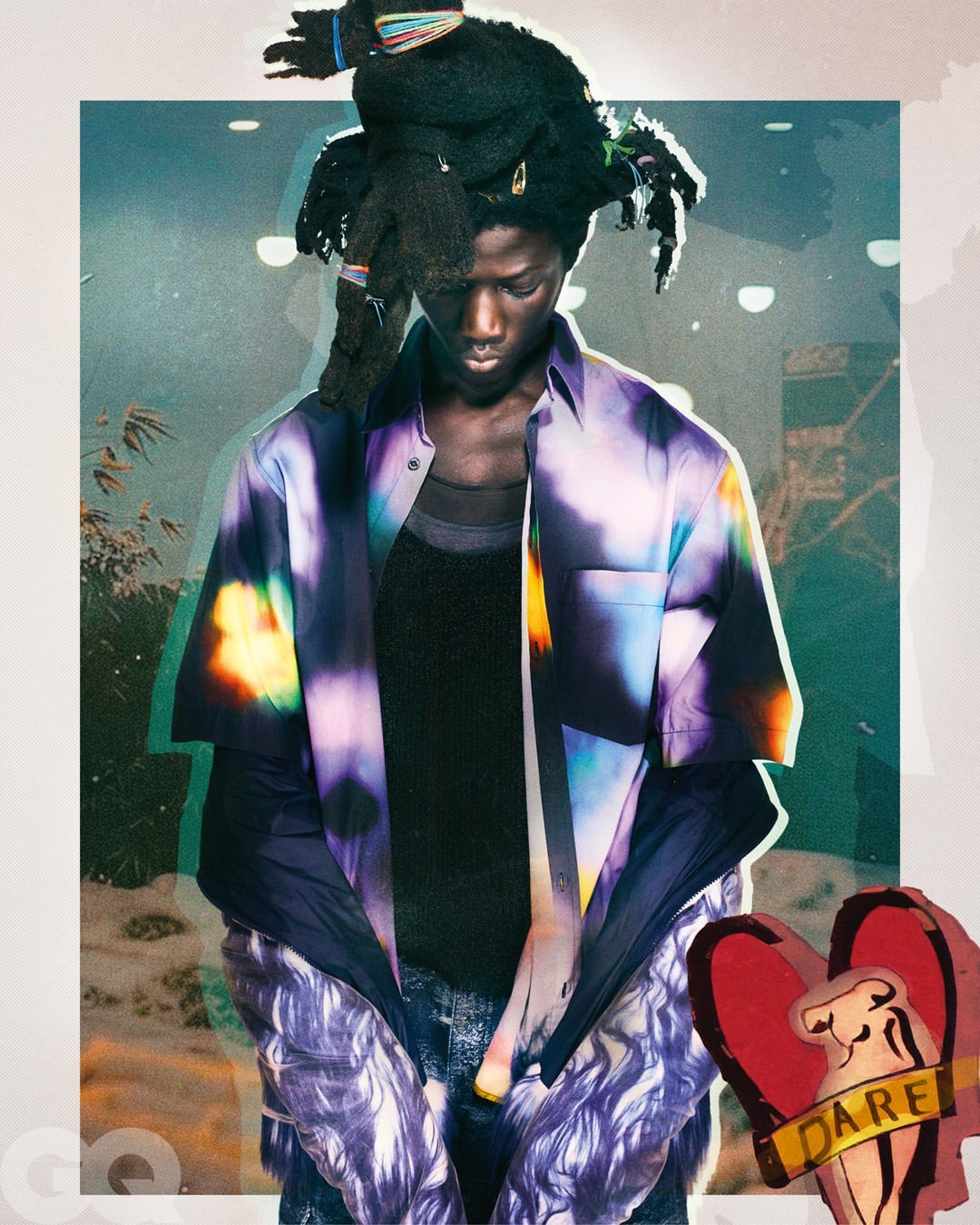 Stylish portrait of a Black man with locs, wearing a colorful patterned shirt, standing against an abstract background with magazine logo.