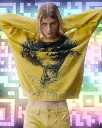 Fashion shot of a person wearing a yellow graphic sweater and pants, arms raised, against a multicolored abstract background.