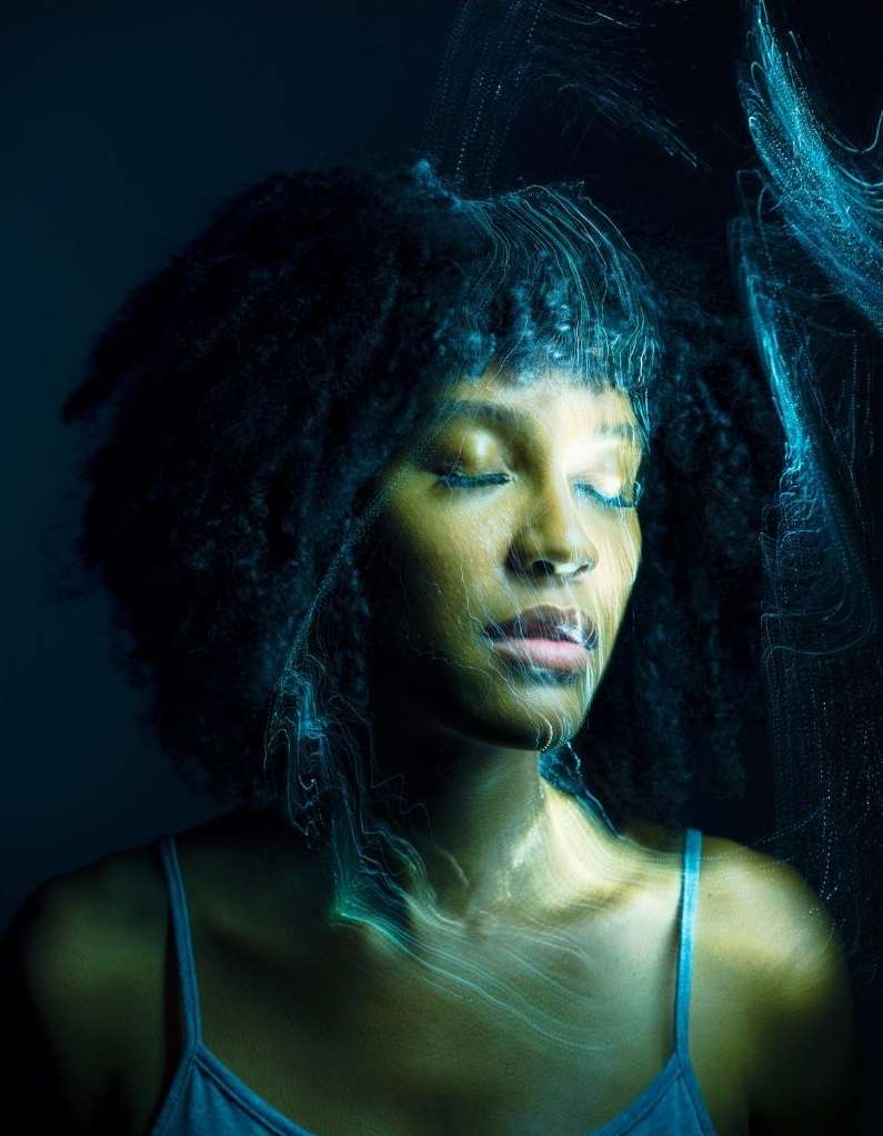 Close-up portrait of an African-American woman with closed eyes, dark hair, and a blue tank top, with soft blue light painting effect.