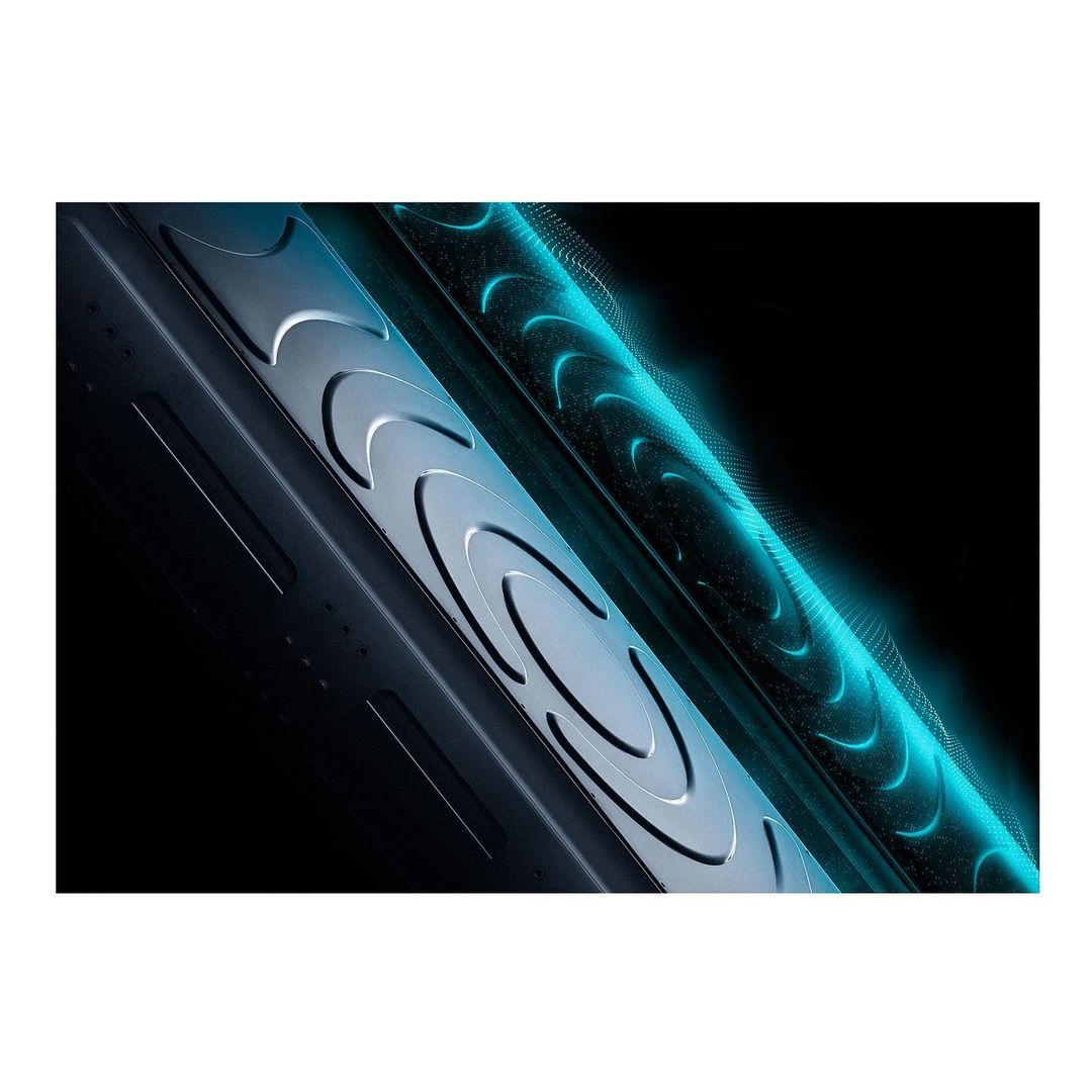 Abstract image showcasing an industrial part with silver accents, circular designs, and teal lighting against a dark background.