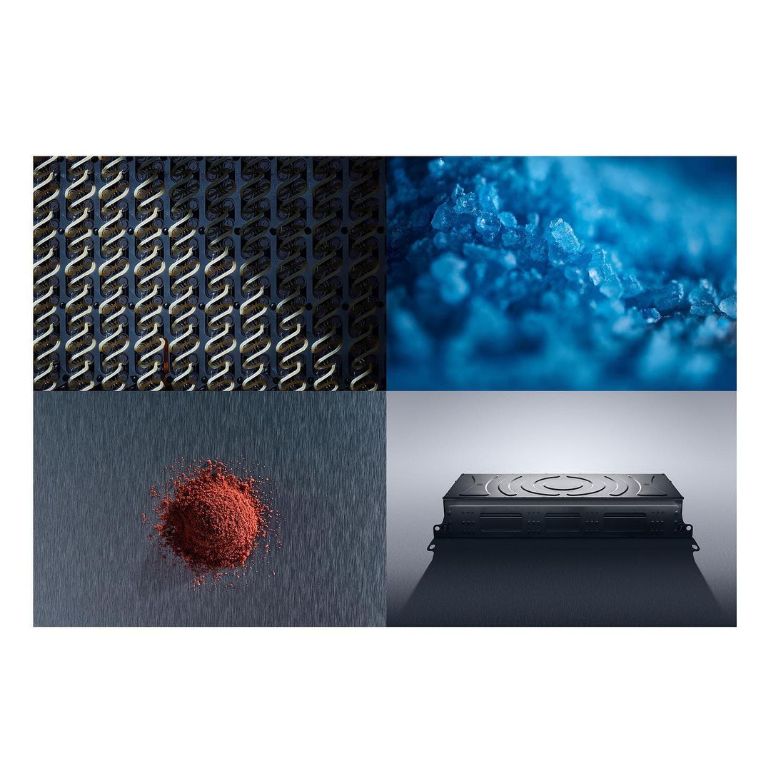 Abstract collage featuring a metal grill, blue crystals, red powder on metal, and a black electronics device on a light grey background.