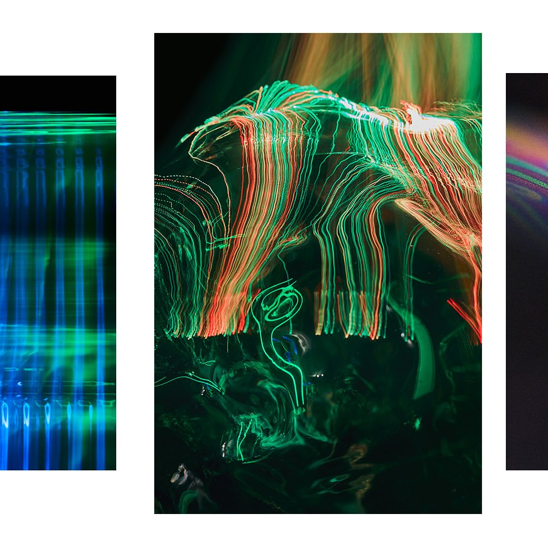 Abstract long-exposure art featuring streaks of green and red light against a dark background, with blurred patterns and textures.