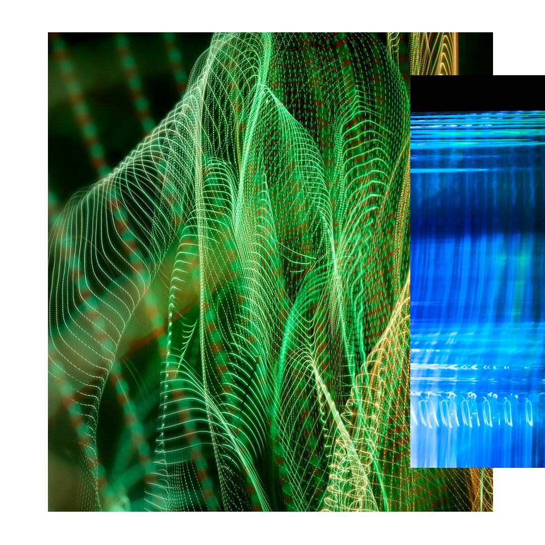 Abstract long exposure featuring patterns of green and white lights in an artistic arrangement with blue light streaks.
