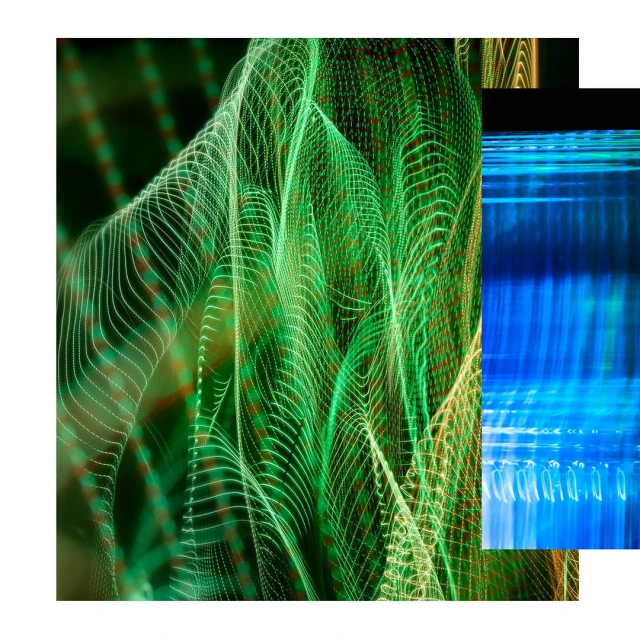 Abstract long exposure featuring patterns of green and white lights in an artistic arrangement with blue light streaks.