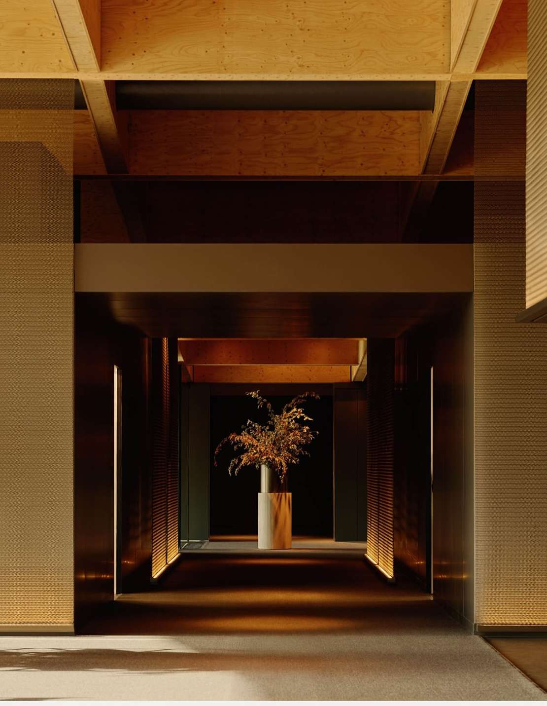 Interior view of a corridor with dark metal walls, a cylindrical vase with branches, and wooden ceiling beams, creating depth and architectural interest.