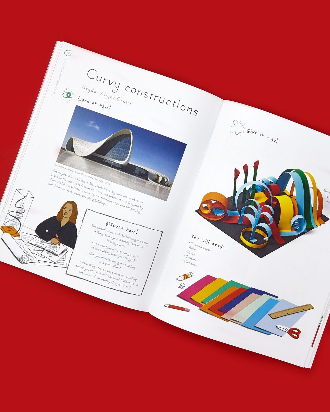Open book spread features colorful paper art craft project instructions, studio photography, vibrant colors on white paper, red backdrop.