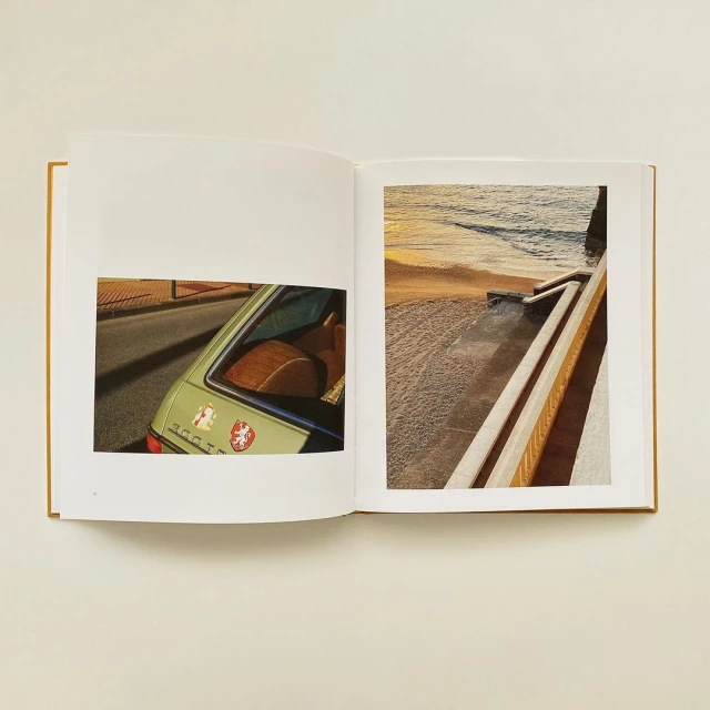 An open book displays photographs of a vintage car and a beach at sunset, blending automotive and scenic elements in a unique layout.