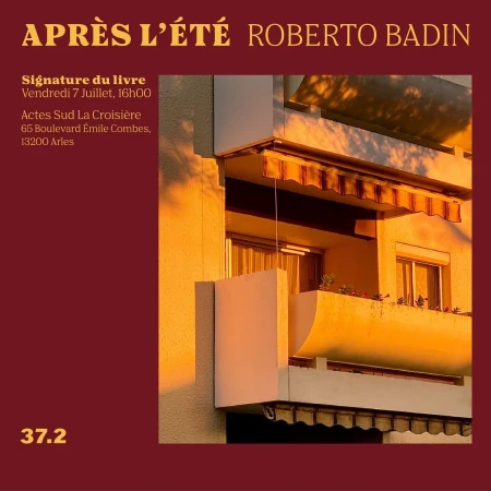 Building facade featuring balconies and windows bathed in warm, golden sunlight, creating a serene urban scene.