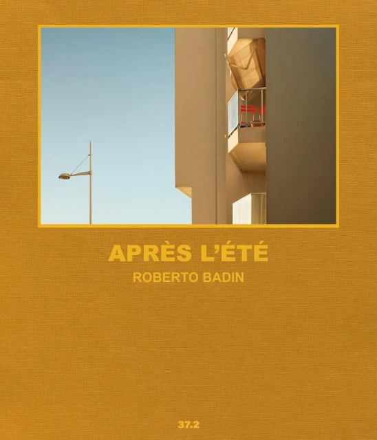 Architectural image of a modern building with a balcony and a partial view of a blue sky framed by a golden border, creating a graphic.