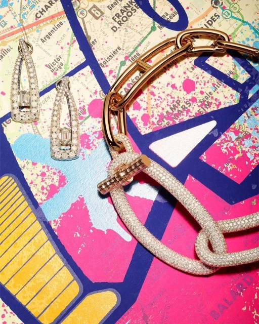 Earrings and a necklace with gemstones are arranged against a colorful map background for a product shot in a jewelry advertisement.