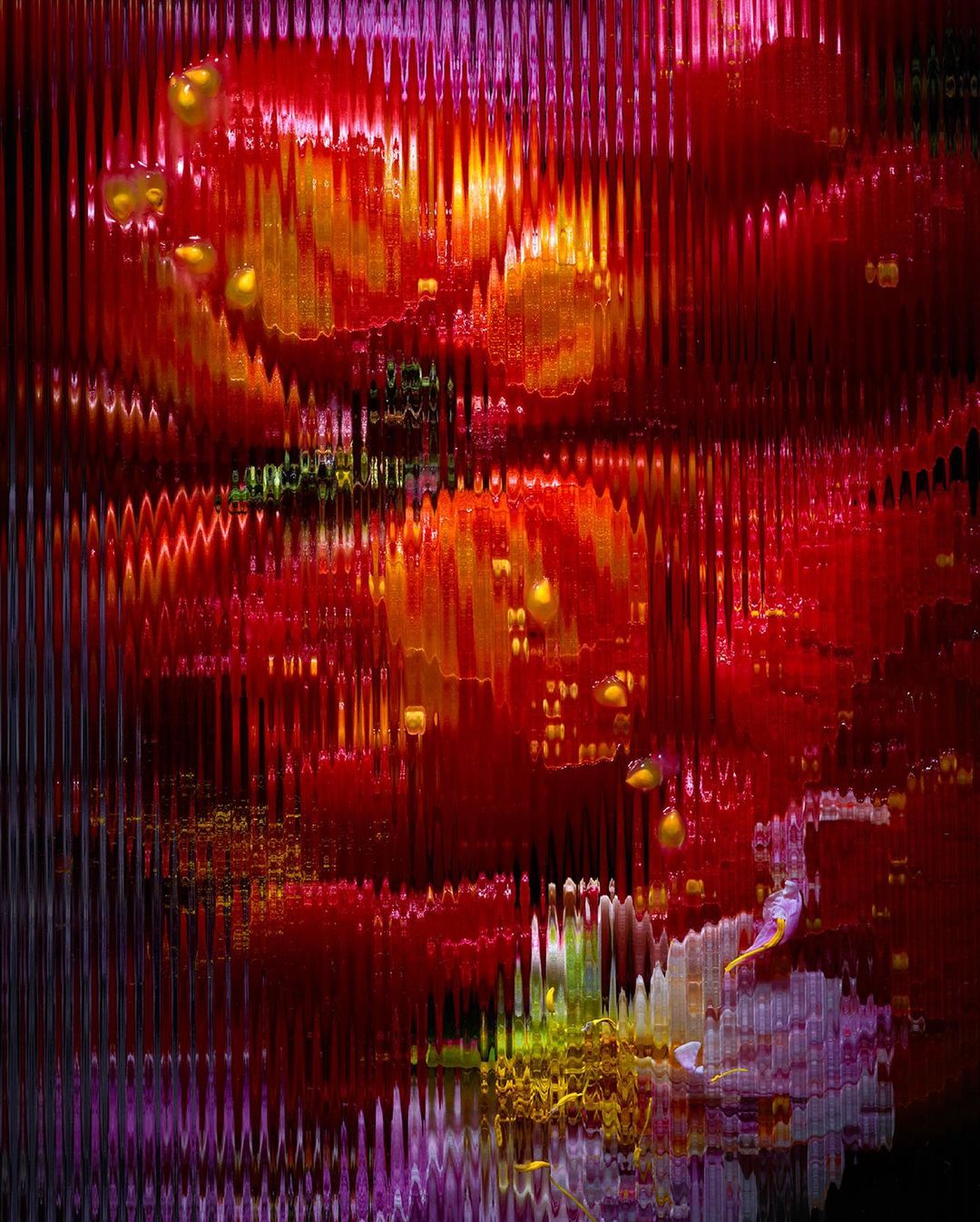 Abstract art with a rippled water effect showing warm colors including red, orange, and yellow, along with hints of purple and green.