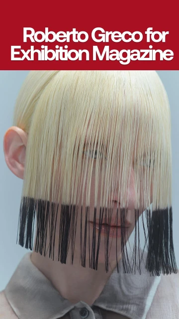 Face framed by blonde hair with black tips in a studio shot for Exhibition Magazine, showcasing a unique beauty and fashion statement.