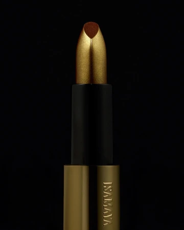Close-up of gold and black lipstick tube on black background, beauty product advertisement with metallic textures.