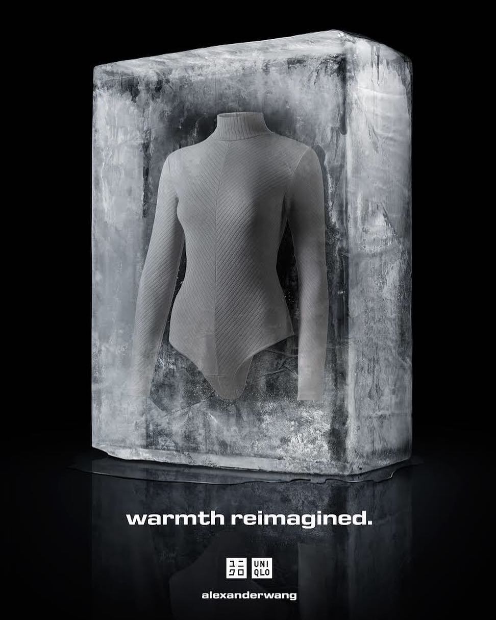 Grey long-sleeve garment encased in a block of textured ice against a black backdrop, advertising warmth reimagined by Uniqlo.