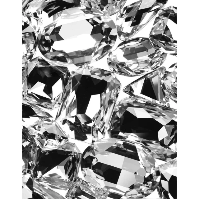 A close-up showcases multiple clear, multifaceted gemstones, displaying their intricate cuts and sparkling reflections against a white backdrop.