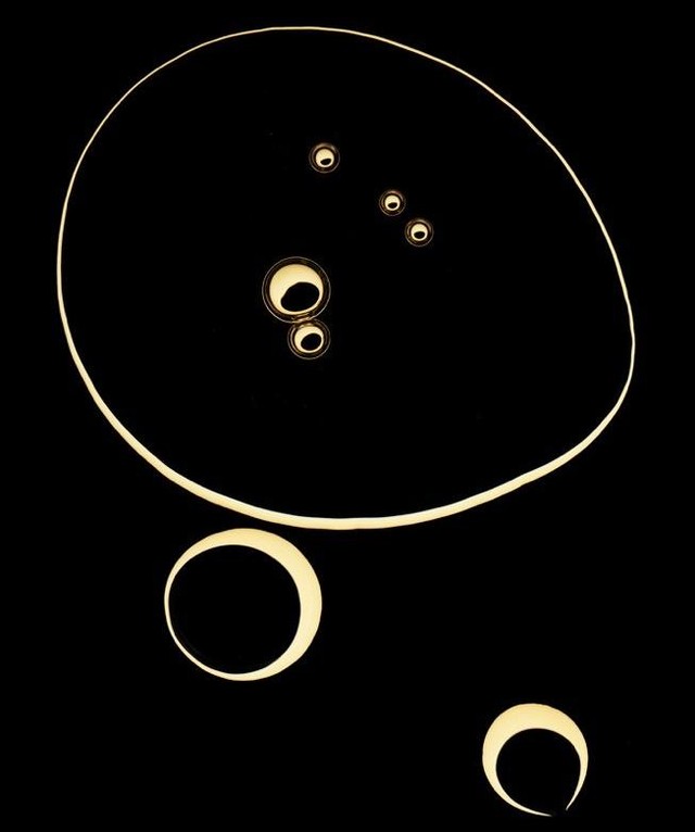 Abstract composition featuring illuminated circular shapes against a dark background, creating a minimalist and modern visual.