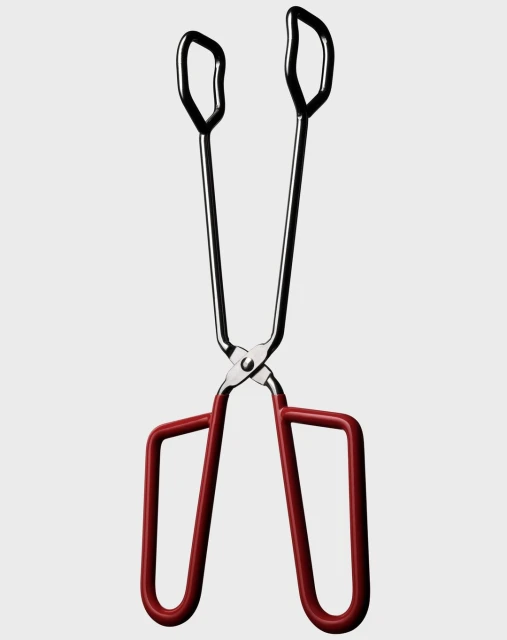 Silver and red cooking tongs on a white background, studio shot. Stainless steel construction. Kitchen utensil for grilling, serving, cooking.