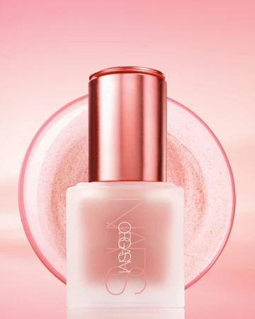 Close-up studio shot of a pink bottle of NARS Orgasm liquid blush with reflective accents and a matching pink background gradient.