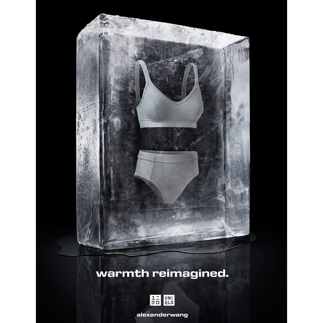 Grey bra and underwear set frozen in an ice block against a black background, promotional image for Alexander Wang and Uniqlo.