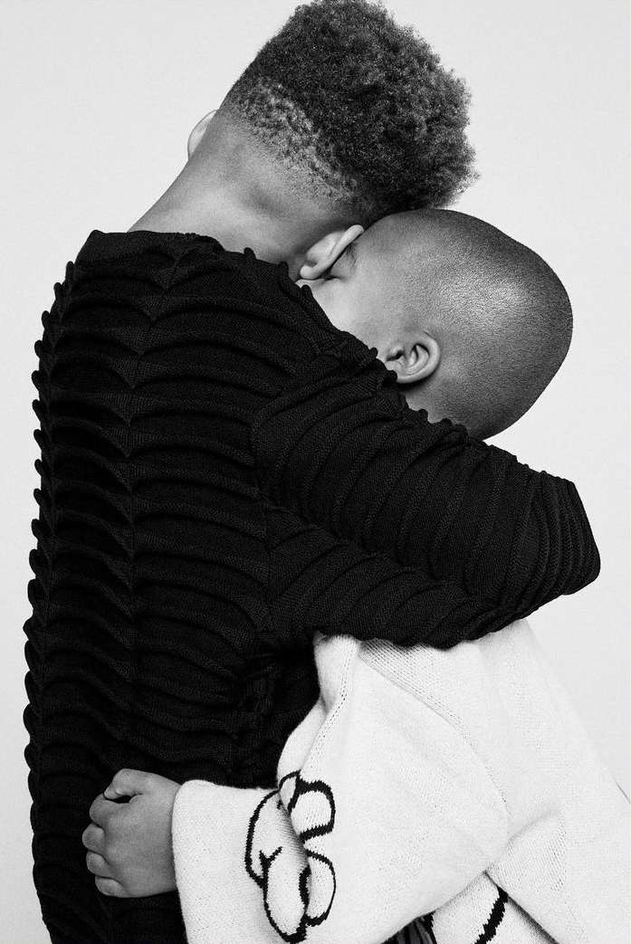 Two people embracing closely in a monochrome studio portrait captured by photographer Robyn Breen Shinn.