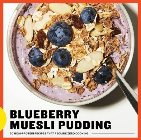 Overhead shot of a bowl filled with blueberry muesli pudding, topped with blueberries, almonds, and muesli for a healthy food recipe.