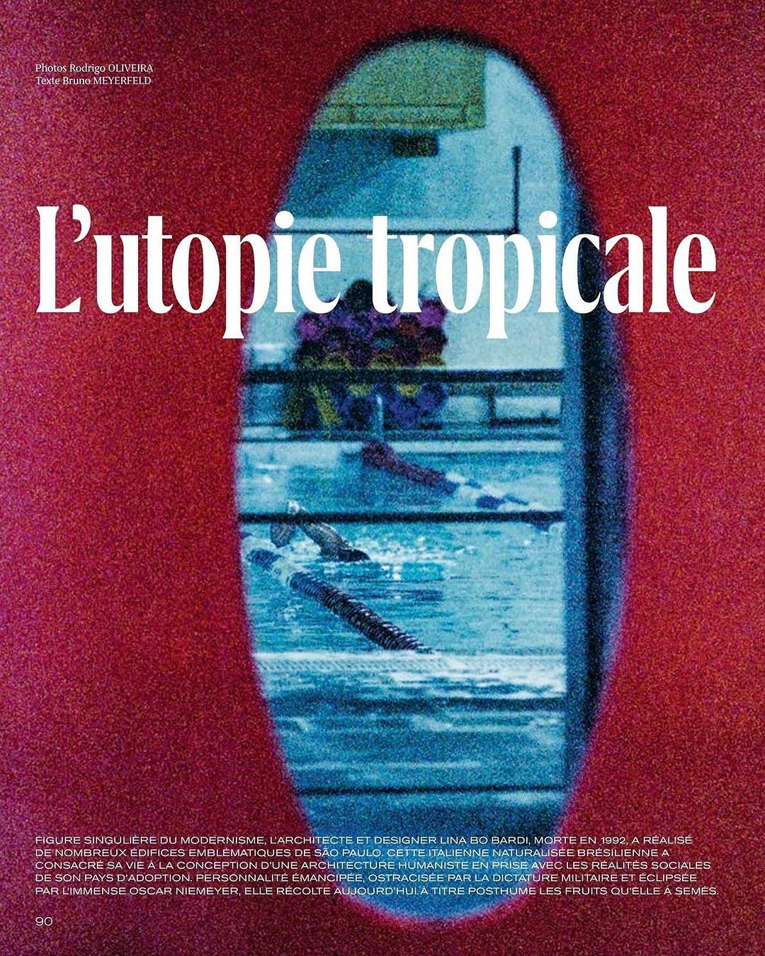 Architectural editorial featuring a swimming pool viewed through an opening in a textured red wall with text overlay.