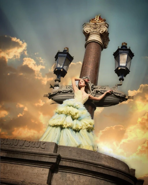 Woman in ruffled gown poses on ornate bridge streetlamp against dramatic clouds and golden sky at dusk in a fashion editorial style.
