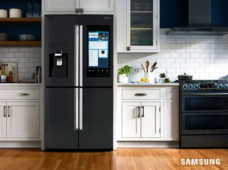 Modern kitchen interior featuring a black stainless steel Samsung refrigerator with a built-in touch screen display and water dispenser.
