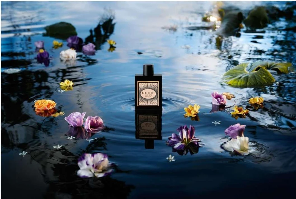 Gucci Bloom Profumo di Fiori perfume bottle surrounded by flowers floating on water, product shot for beauty and fashion industry.