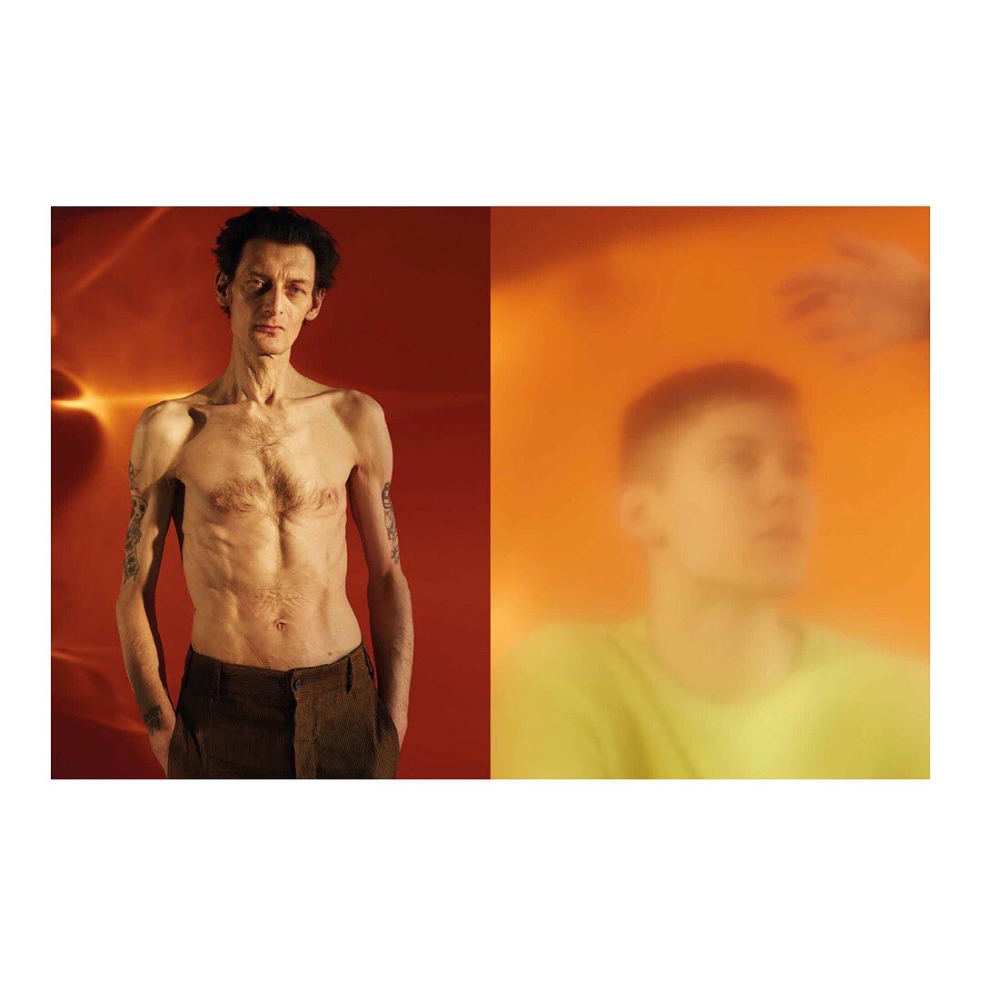 Split-screen image showcasing two young men; one shirtless with tattoos against a red backdrop, the other blurred in a hazy orange setting.