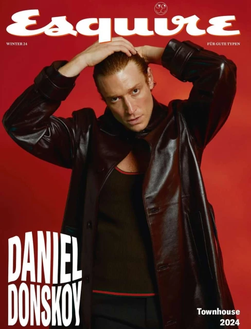 Esquire cover featuring model Daniel Donskoy in a black leather jacket and dark tank top against a red background. Winter 2024.