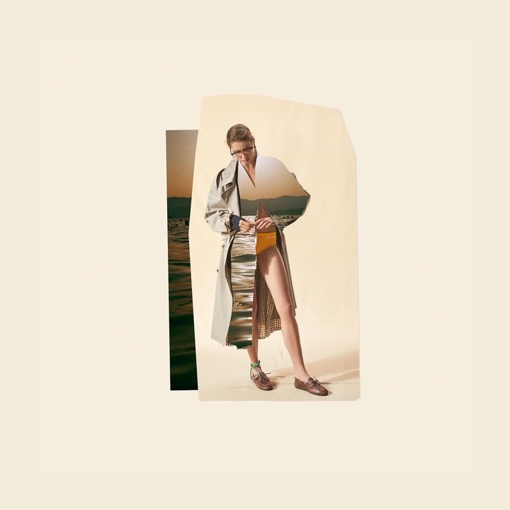 Woman in a trench coat and skirt with landscape overlay standing in a collage against a light beige background in a studio.