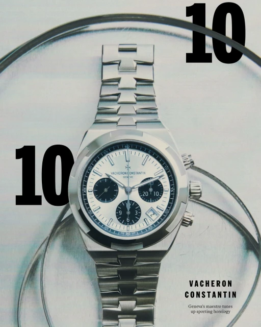 Silver Vacheron Constantin wristwatch with silver bracelet against a light grey backdrop with a large numeral ten in black