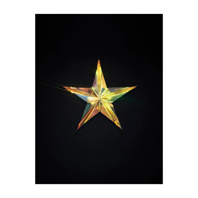 Iridescent star-shaped decoration on a black backdrop, featuring a reflective surface with hues of gold, green, and purple.
